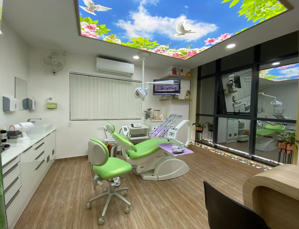 GardenCity Smiles treatment room with a green dental chair and clinical equipment