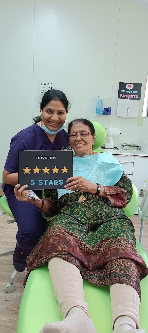 A patient and clinician holding a five-star sign at GardenCity Smiles™