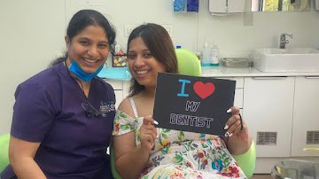A visitor and clinician with an I Love My Dentist sign